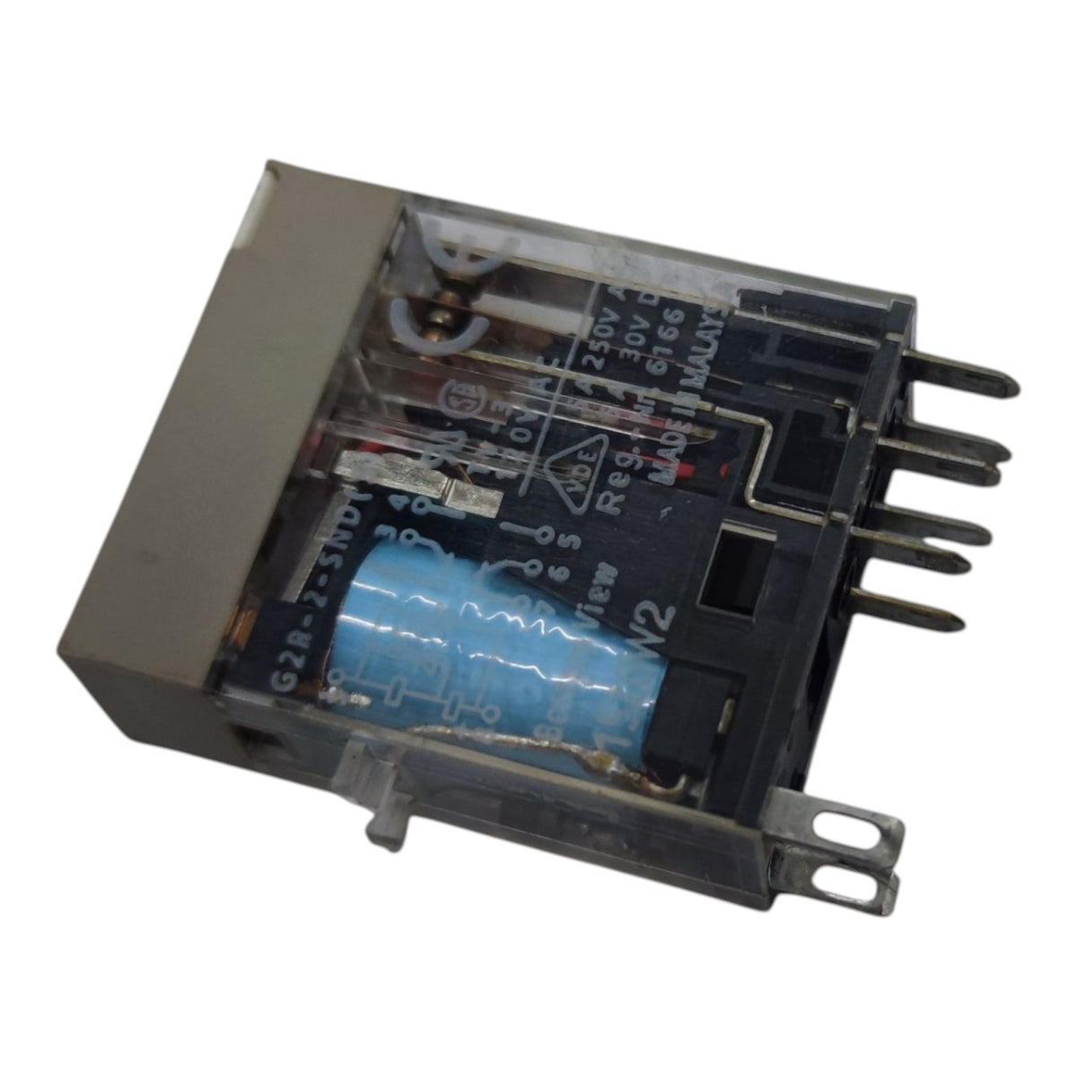A black electrical relay component with a clear plastic cover, showing internal details including a blue capacitor, white printed technical markings, and metal terminal pins on a white background.