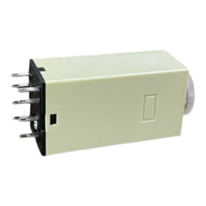 A small rectangular electronic component with a cream-colored plastic body, a black terminal base with multiple metal pins on the left, and a silver cylindrical end on the right, shown on a plain white background.