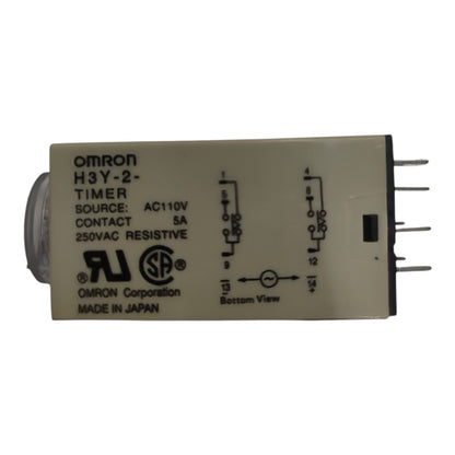 An Omron H3Y-2 timer contact relay with a beige plastic housing, black printed technical specifications and wiring diagrams, and a silver metal core on one end, shown against a plain white background.