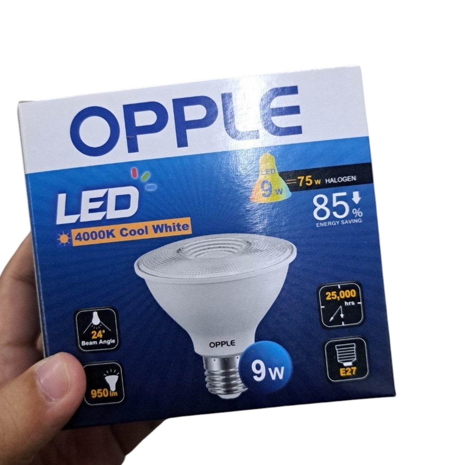 A hand holding an OPPLE LED light bulb box. The packaging is blue and white with a graphic of a cool white PAR30 LED bulb, highlighting features like 4000K cool white light, 9W power, and 85% energy saving.