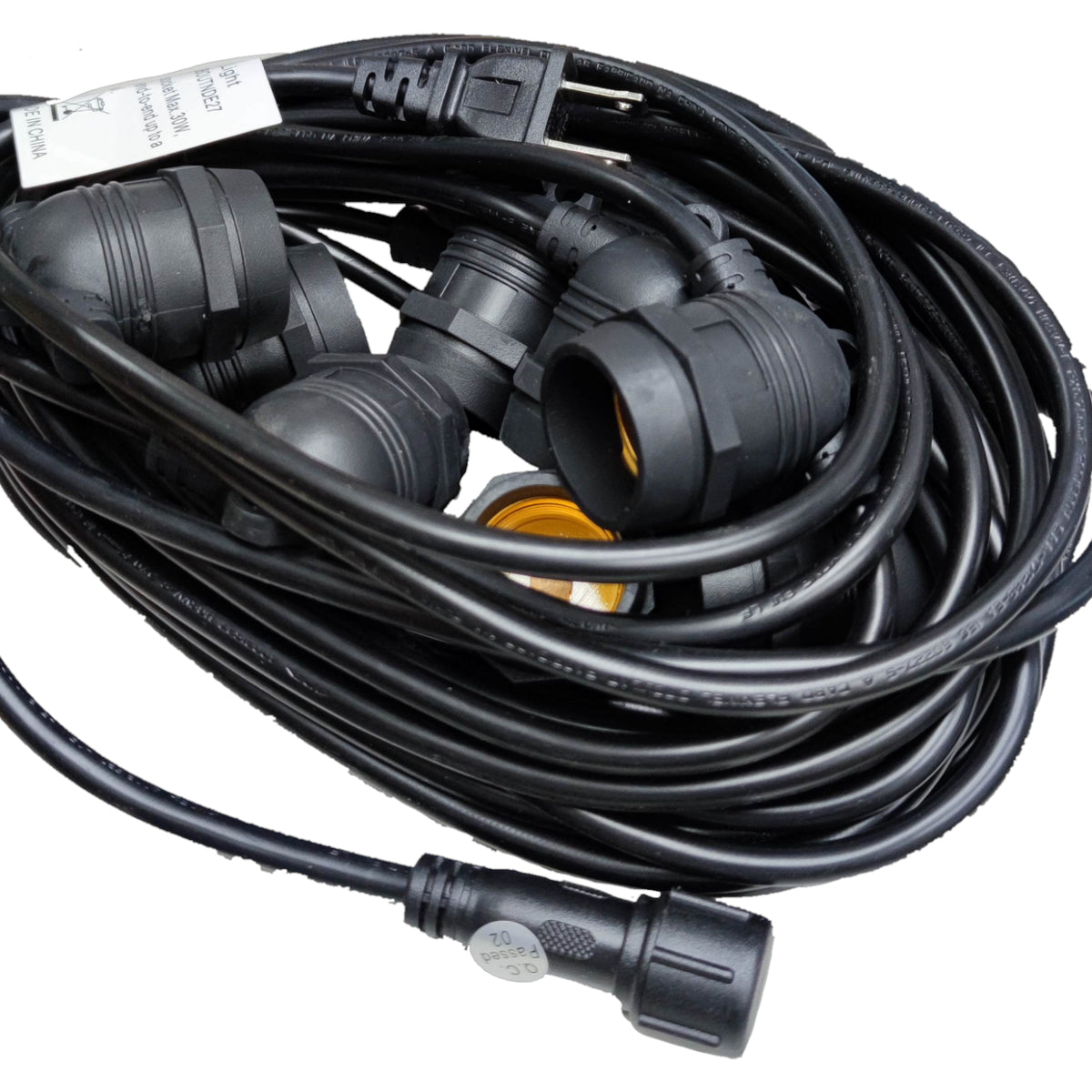 Coiled black extension cord with multiple plugs on a white background