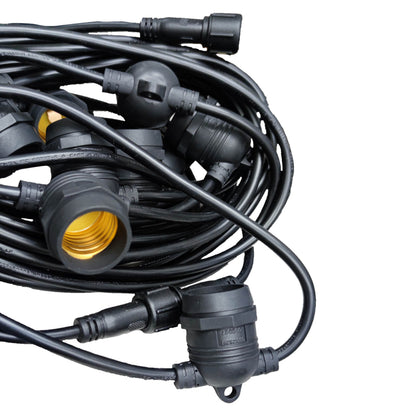 Coiled black cable with connectors on a white background