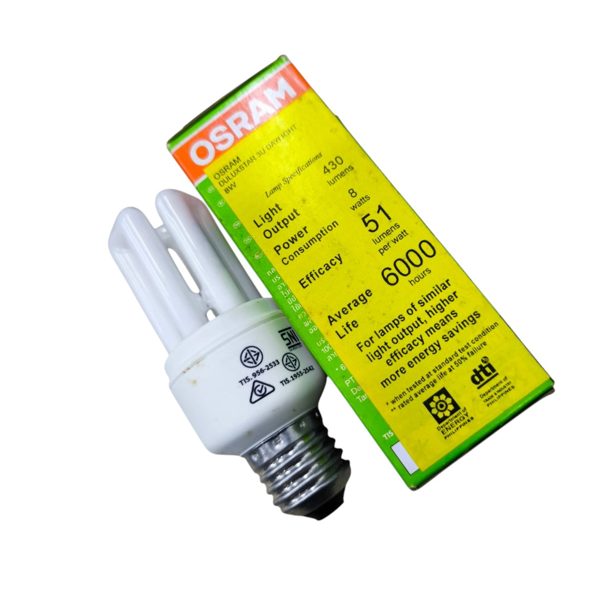 An OSRAM compact fluorescent light bulb with a white U-tube body and screw base, shown next to its yellow and green product packaging box on a plain white background.