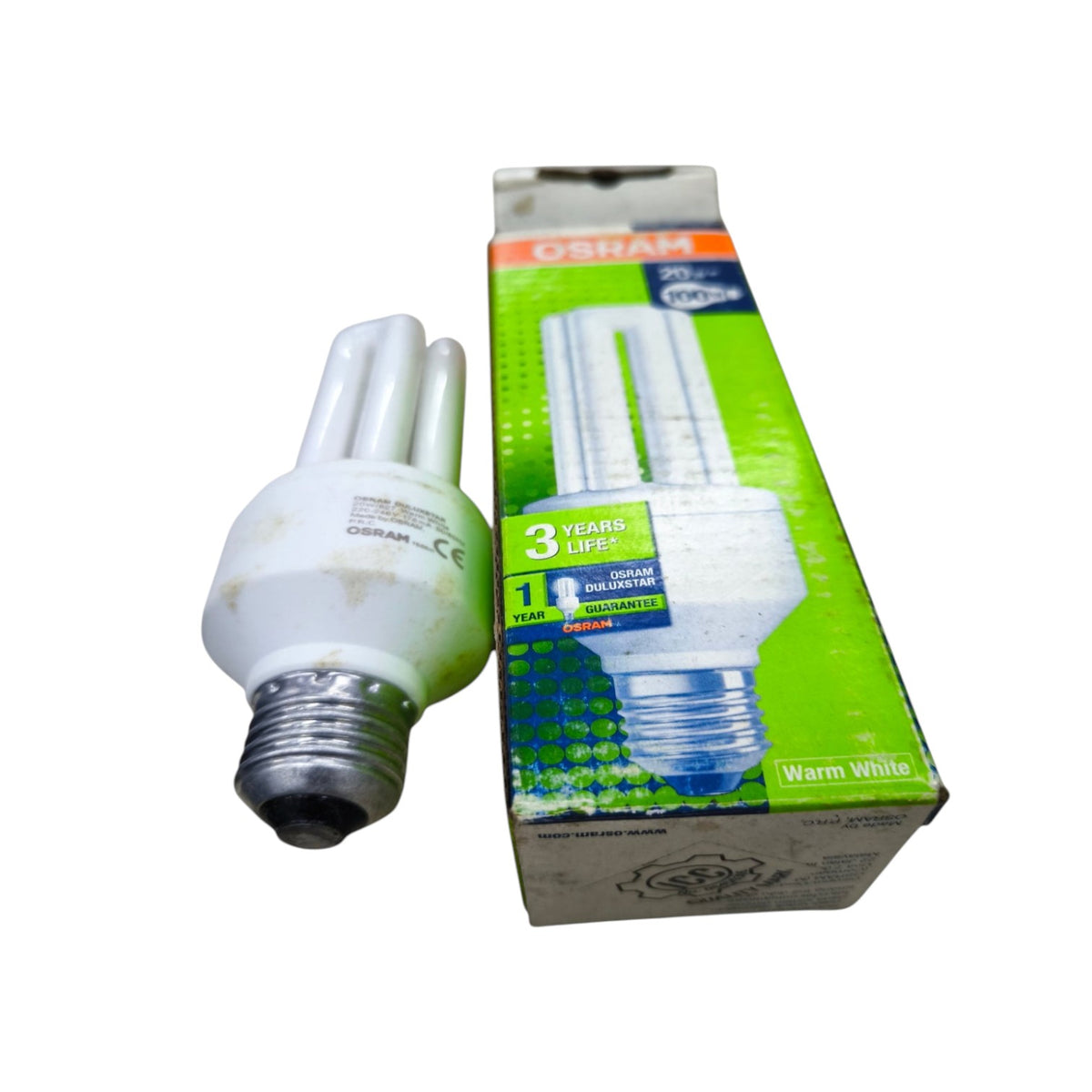 A compact fluorescent light bulb with a silver E14 screw base shown next to its green and white Oshkorn retail packaging box on a white background.