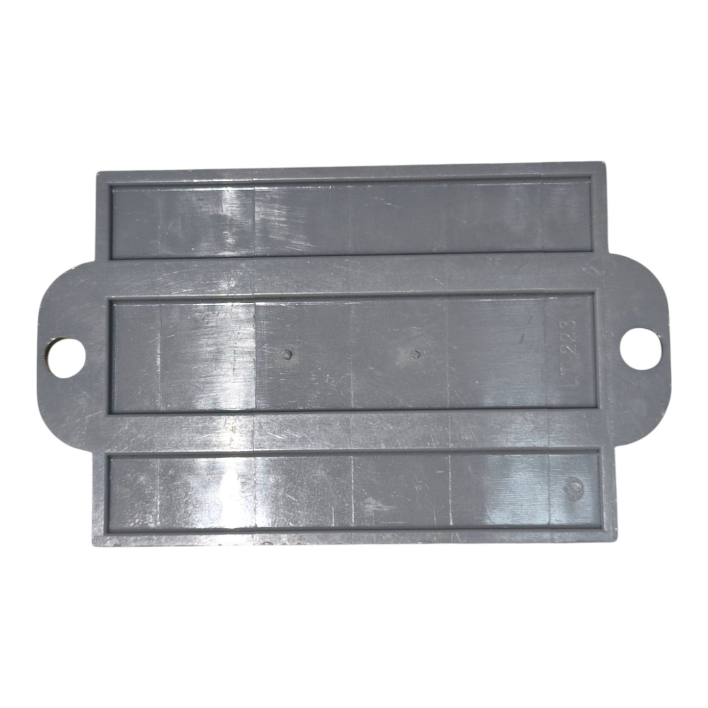 Metallic rectangular component with two holes on a white background