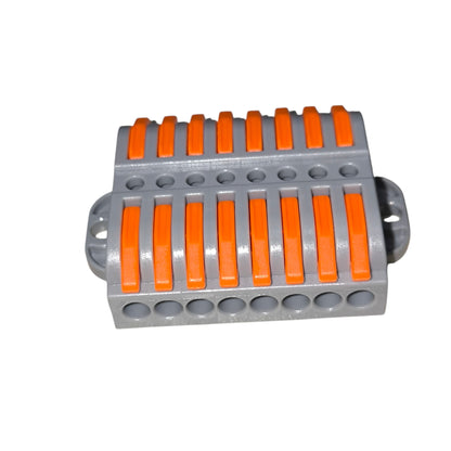Gray and orange plastic component on a white background
