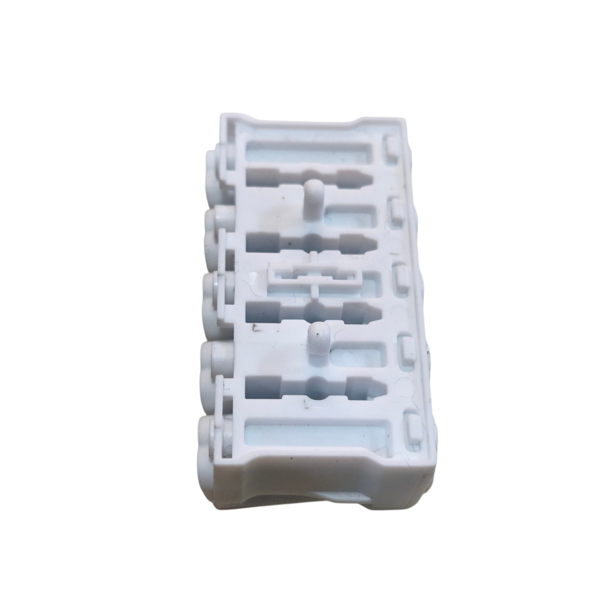White plastic component with multiple holes on a white background