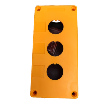 An orange plastic electrical junction box cover with three circular openings for cables, shown on a plain white background.