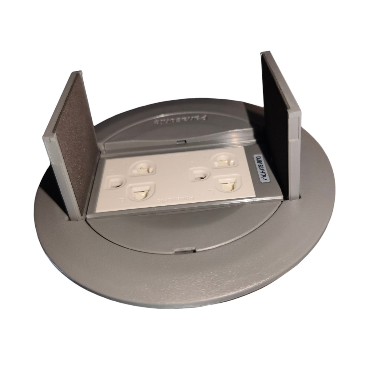 A circular gray metal electrical outlet cover with two upright protective guards and a white outlet cover plate inserted, photographed on a plain white background.
