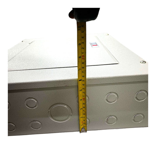 A white metal electrical junction box with circular conduit penetrations, shown with a yellow tape measure standing vertically to indicate its height against a plain white background.