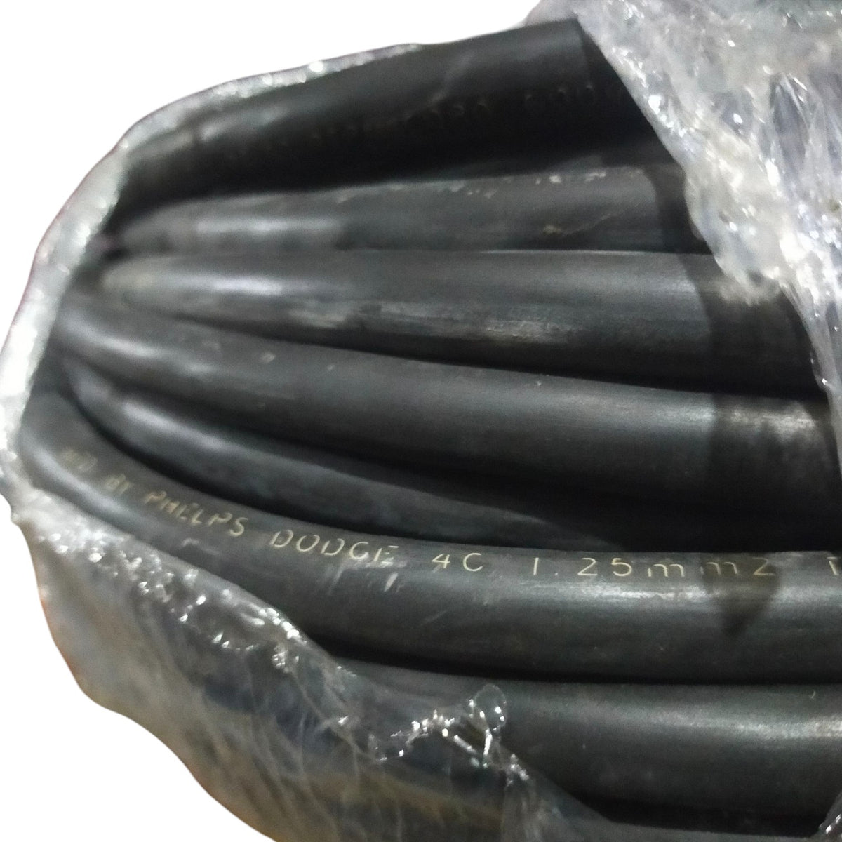 Coiled black cable with visible branding on a white background