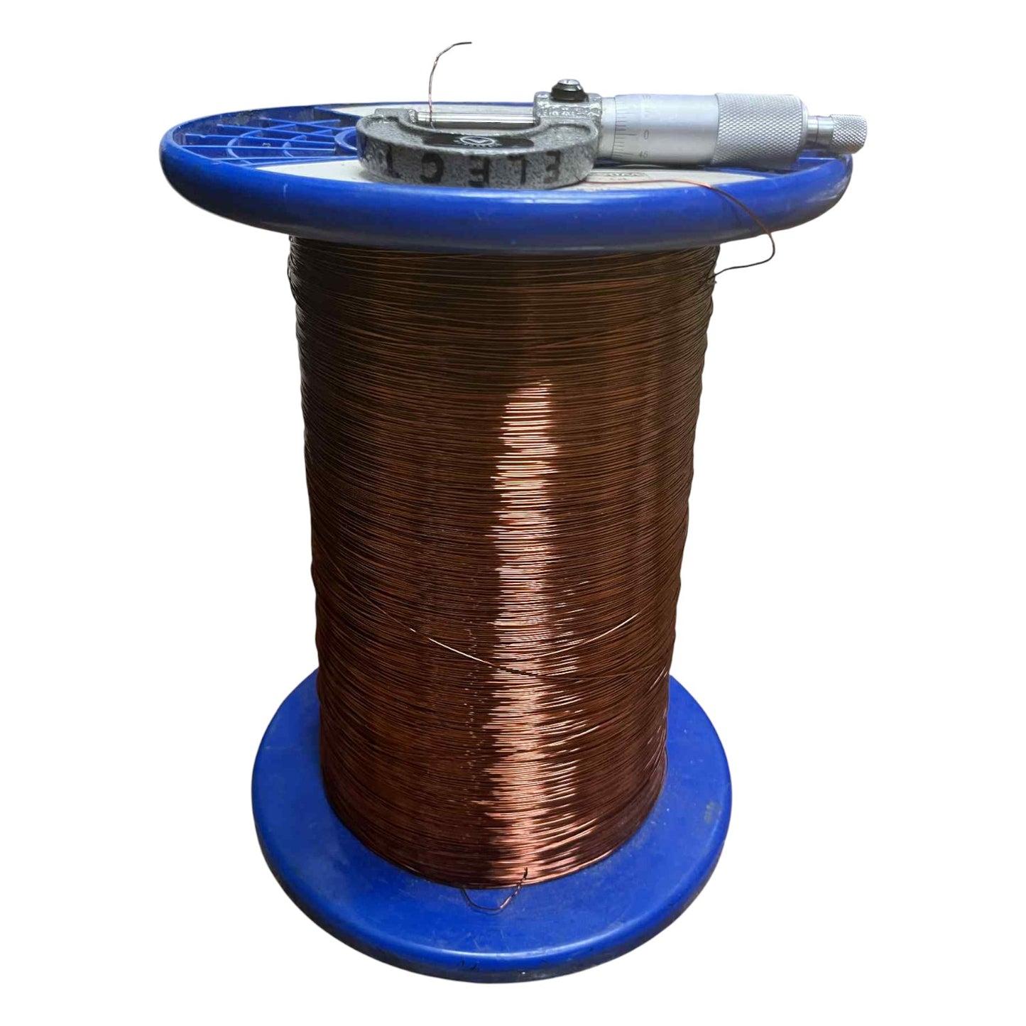Spool of wire with a tool on a blue stand against a white background Philflex 1 KG Magnet Wire AWG 23 Enameled Copper Wire 0.55mm Heavy Formix Approx 416.67 Meters Per Roll Electx Electrical Supply