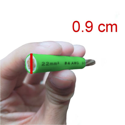 A hand holding a small green screwdriver bit to show its size, with red text reading '0.9 cm' and a red measurement marker on the bit.