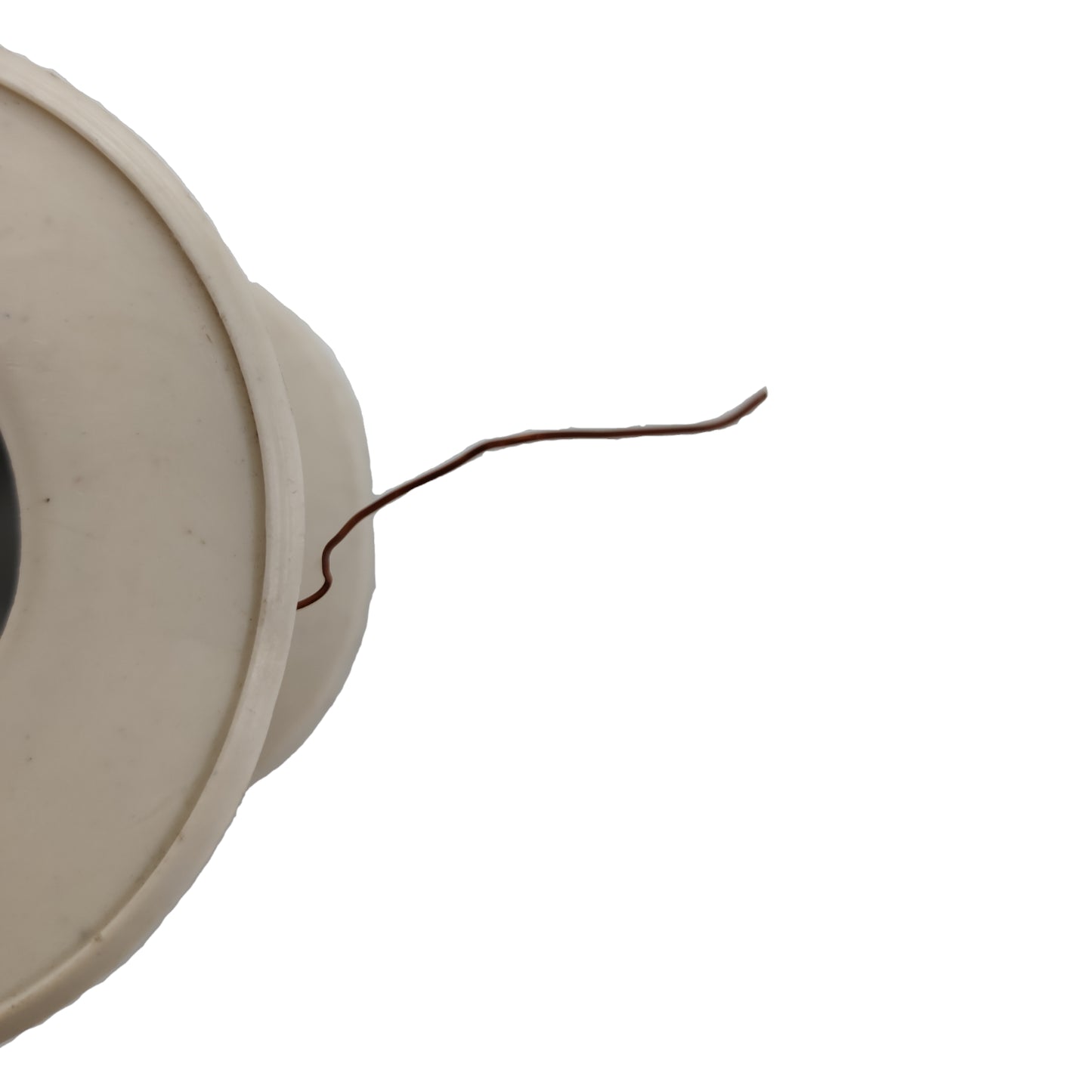 Close-up of a beige circular object with a thin wire on a white background Philflex 50 Grams Magnet Wire AWG 40 Enameled Copper Wire 0.08mm Single Formix Approx 1111.11 Meters Per Roll Electx Electrical Supply