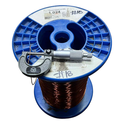 Blue spool of wire with a micrometer on top against a white background