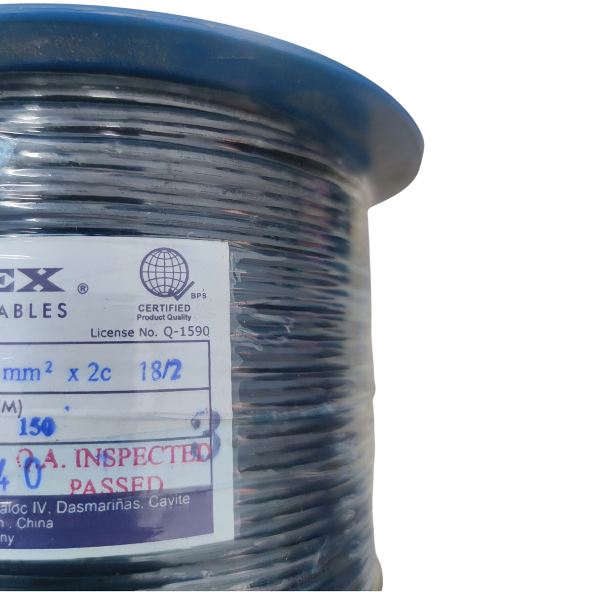 A close-up of a spool of black cable with a blue outer rim and a white product label showing the brand CX Cables and technical specifications.