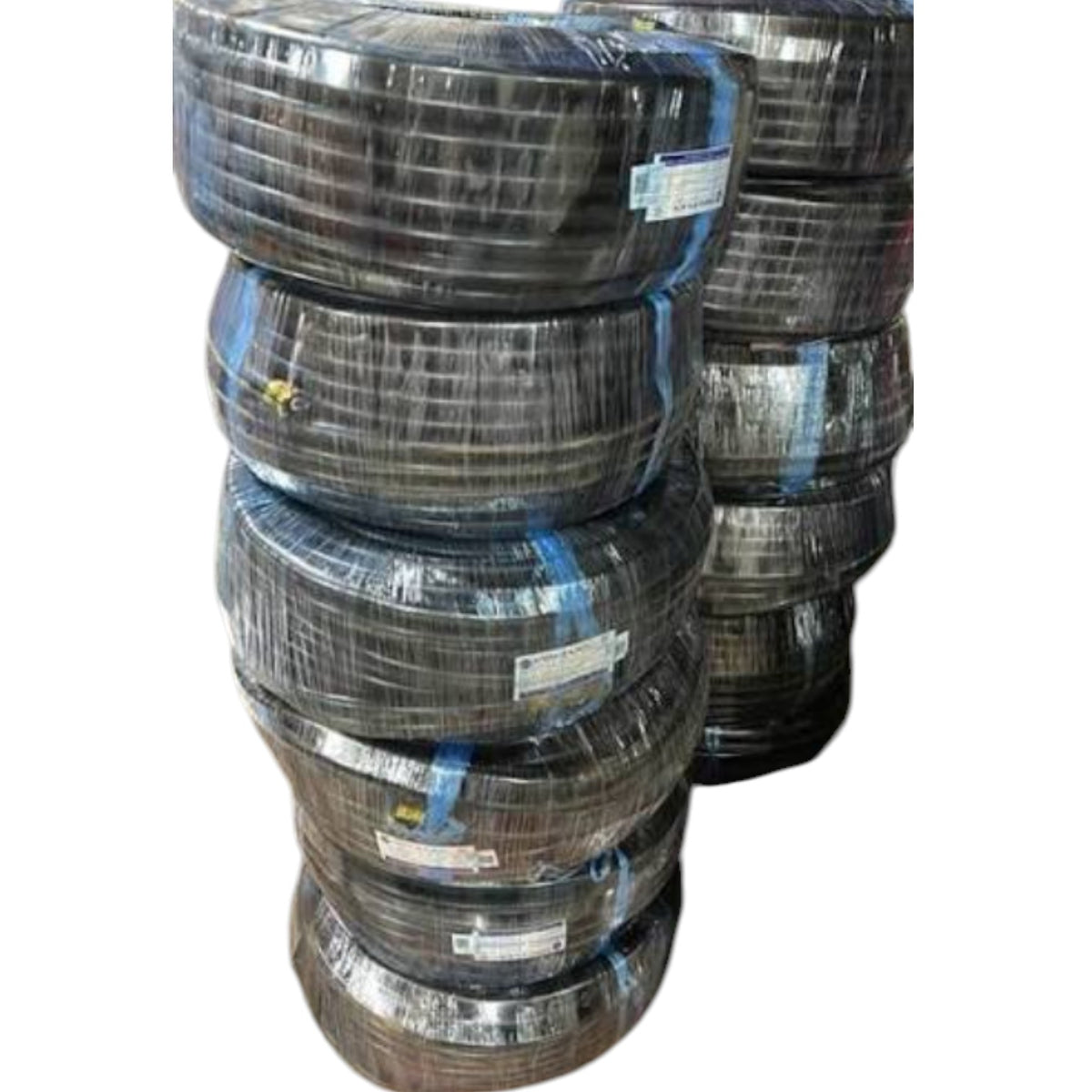 A stack of black plastic-wrapped tires secured with blue straps, isolated on a white background.
