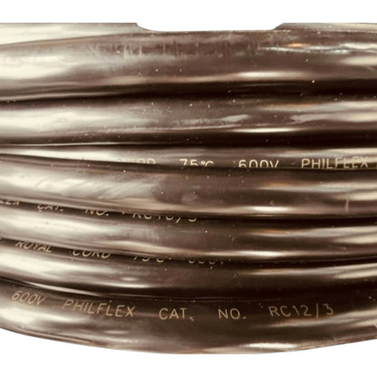 A close-up of a coiled black electrical cable with white printed text reading '600V PHILFLEX' and 'CAT. NO. RC12/3'.