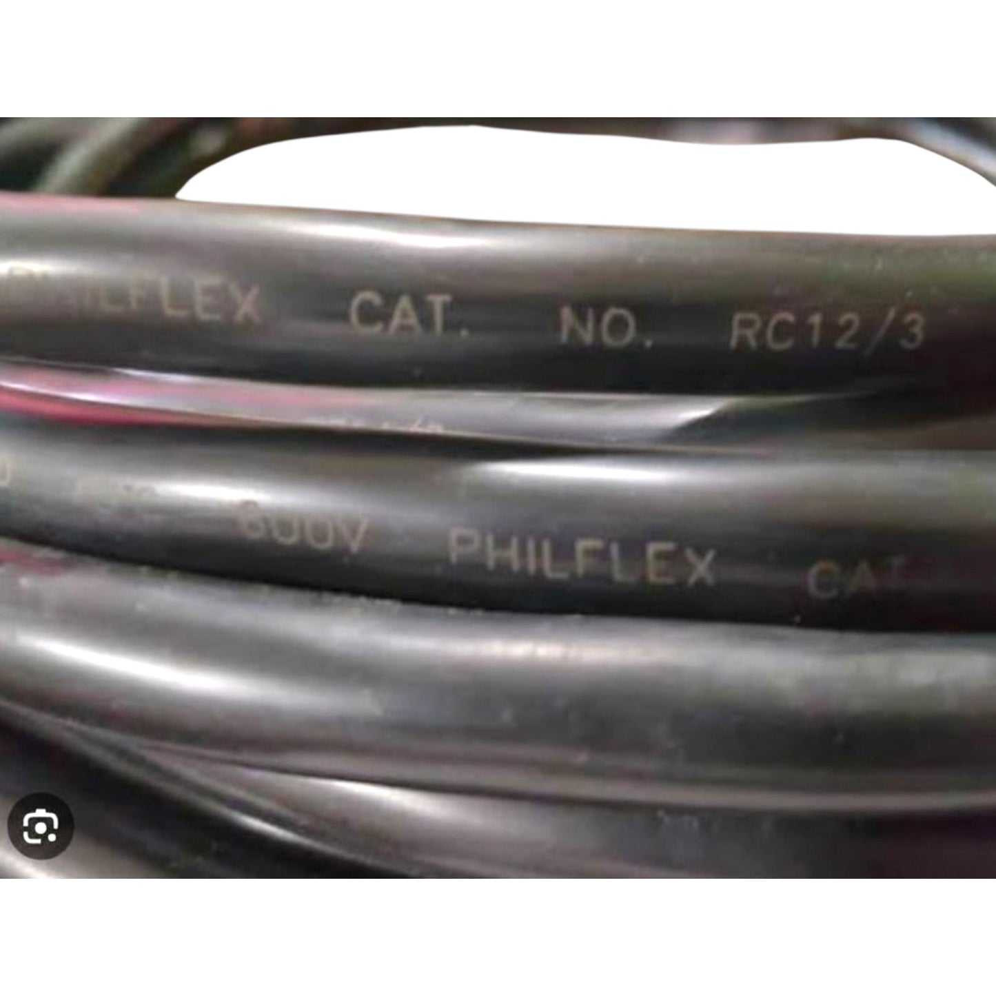 Close-up of coiled black Philflex hydraulic hose with white printed text including 'PHILFLEX', 'CAT.', 'NO.', and 'RC12/3'.