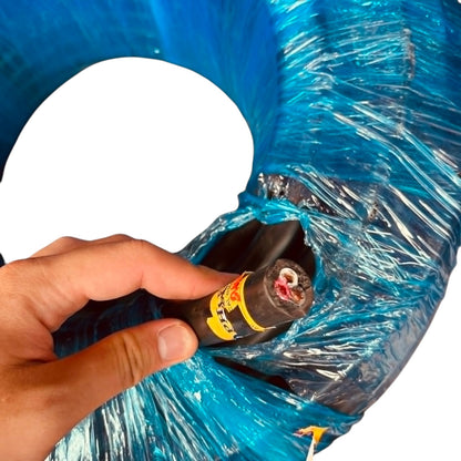 Hand holding a black and yellow tool near a coiled blue cable on a white background