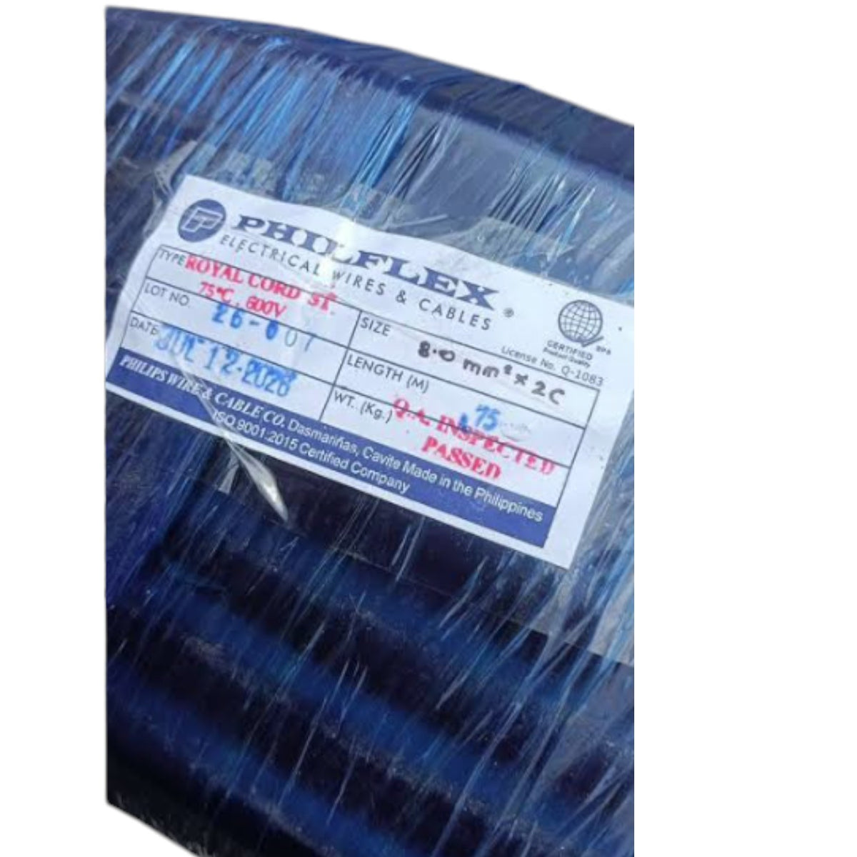 A coil of Philflex Royal Cord 3x3.0 GV electrical wire wrapped in protective blue plastic, with a white and blue product label showing details like size, length, and inspection status.