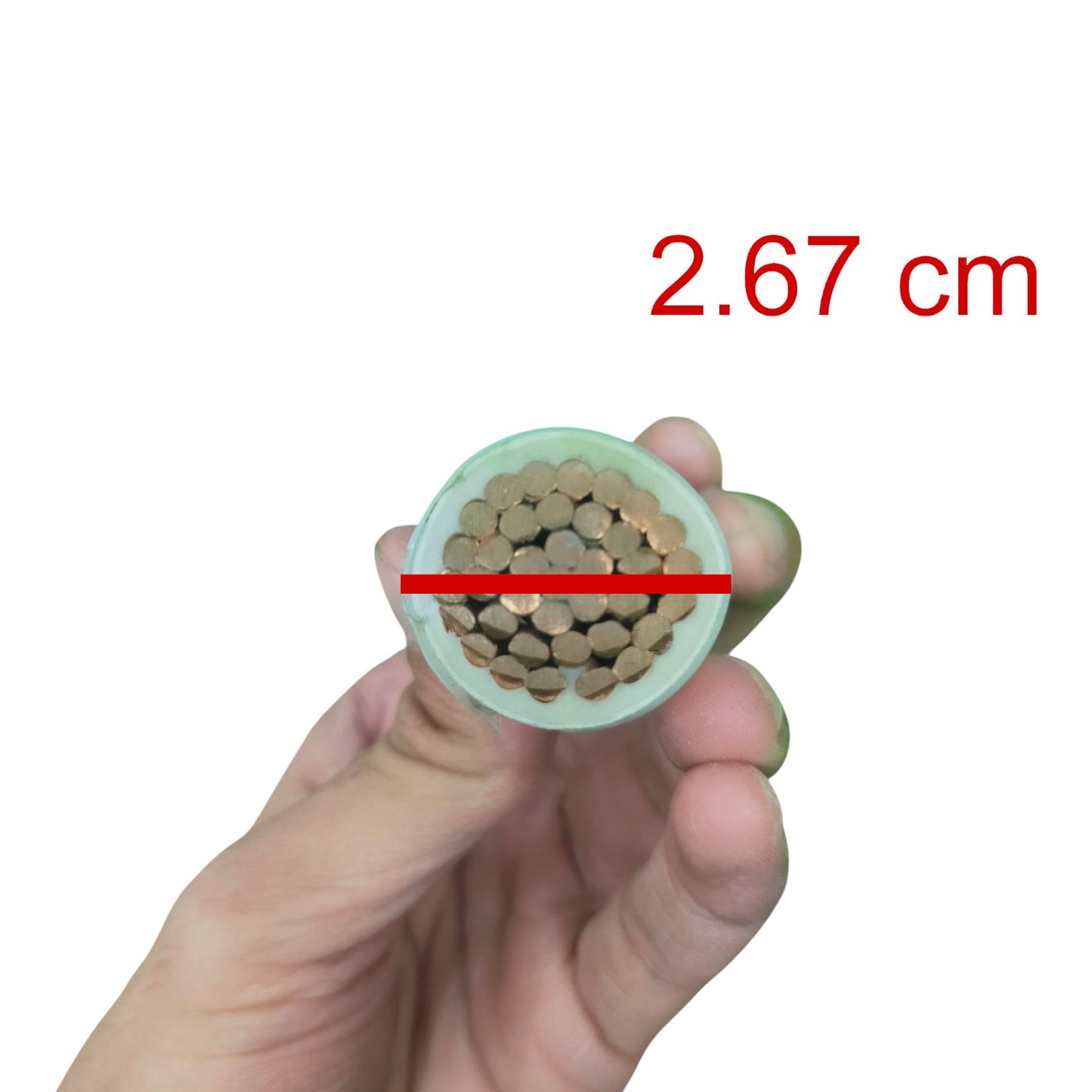 A hand holding a round cross-section of a brown cylindrical material, with a red horizontal line and red text reading 2.67 cm indicating the diameter.