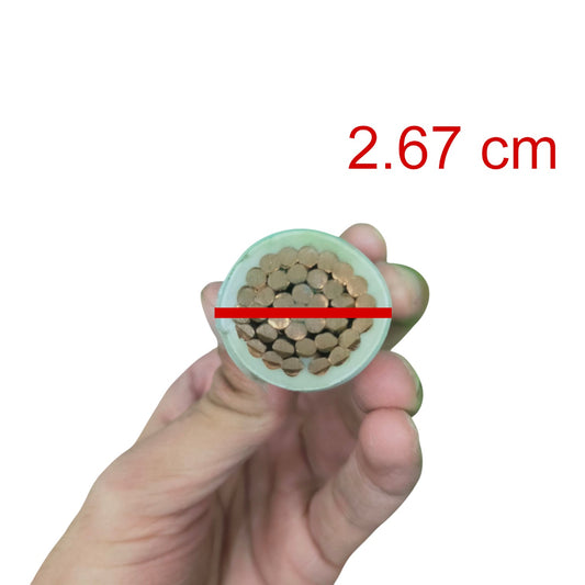 A hand holding a round cross-section of a brown cylindrical material, with a red horizontal line and red text reading 2.67 cm indicating the diameter.