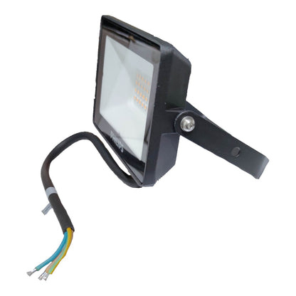 Black outdoor flood light with wiring on a white background