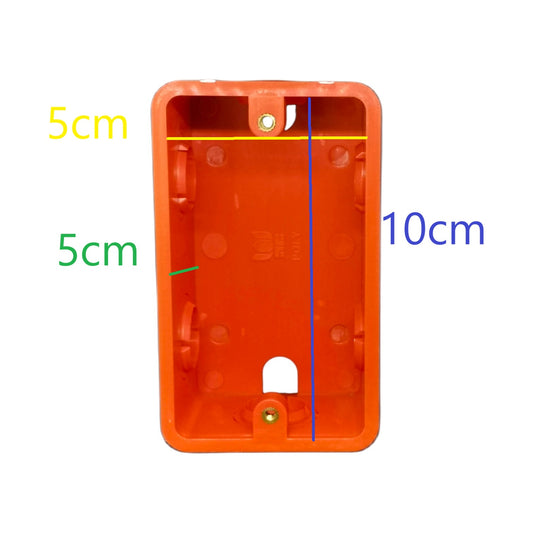 An orange plastic electrical wall box or socket cover shown on a white background with overlaid dimension lines and text indicating measurements of 5 cm, 5 cm, and 10 cm.