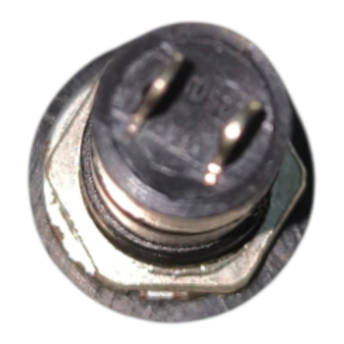 A small round metal electrical component with two pins on top, photographed against a plain white background.