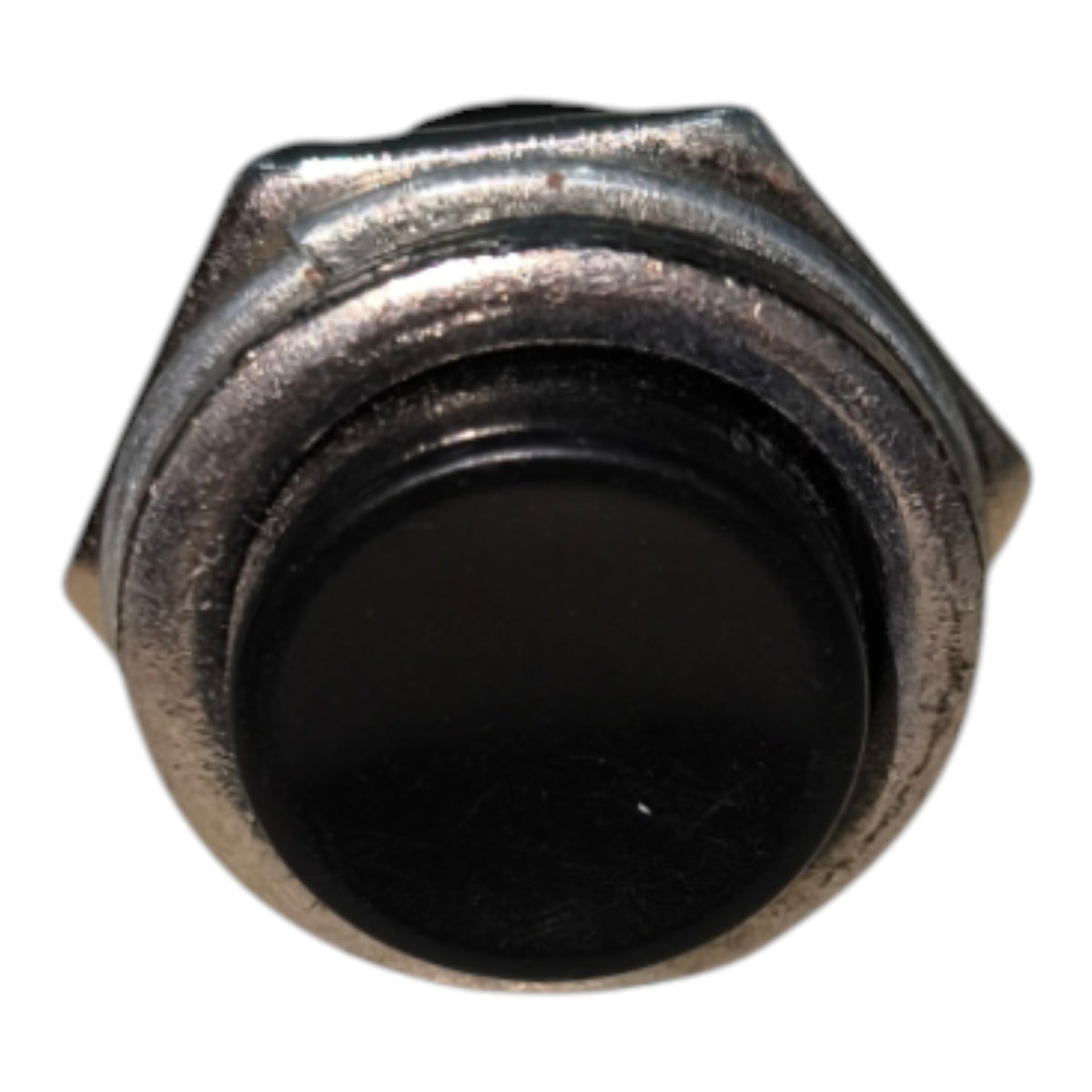 A small industrial toggle switch with a black circular button and a weathered silver metal housing, isolated on a white background.