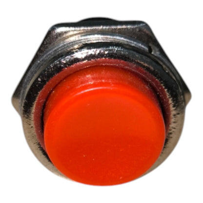 A close-up of a metal push-button switch with a bright orange-red circular button and a silver-toned hexagonal housing, isolated on a white background.