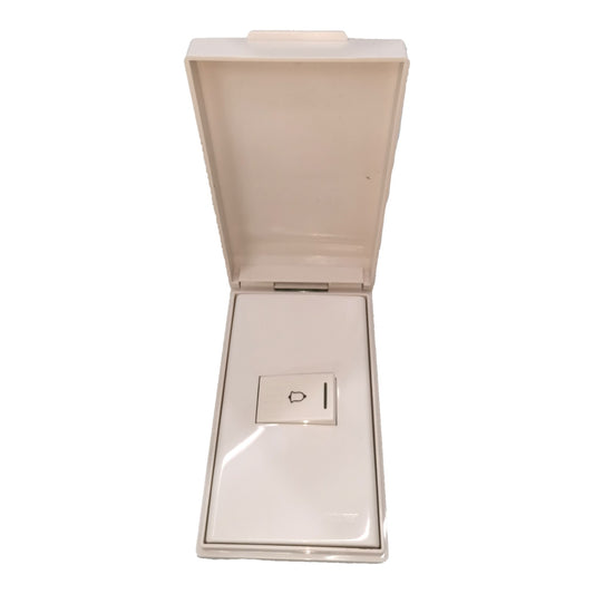 An open cream-colored plastic case with a hinged lid, showing a small rectangular insert with a power symbol on a white background.