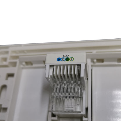 Close-up of a white CAT6 RJ45 network module connector with colored pin labels (blue, green, orange) on a white plastic housing.