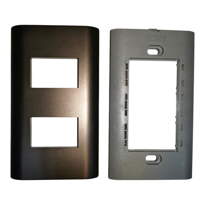 Two rectangular wall plate covers shown side by side on a plain white background: a dark metallic bronze/black cover with two cutouts on the left, and a matte gray cover with one large cutout on the right.