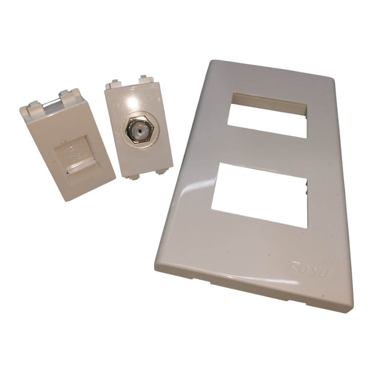 A set of beige plastic wall outlets or panel components on a plain white background, including a large rectangular faceplate with two cutouts and two smaller connector pieces.