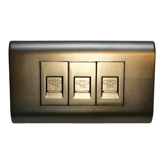 A three-button telephone switch panel with metallic gold buttons and a matching dark metallic faceplate, isolated on a white background.