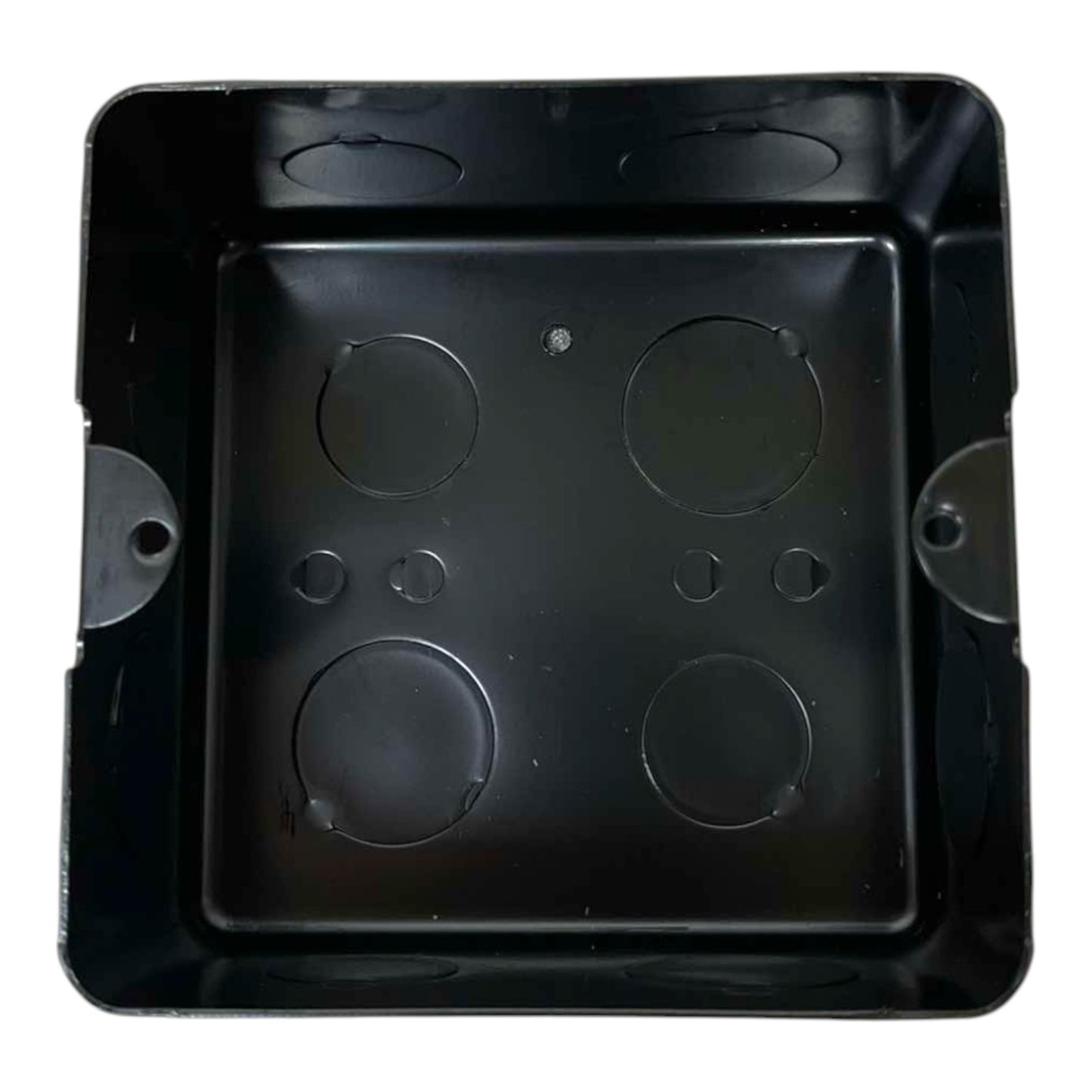 A black plastic electrical junction box with four circular screw terminals on the bottom plate, photographed from directly above on a white background.