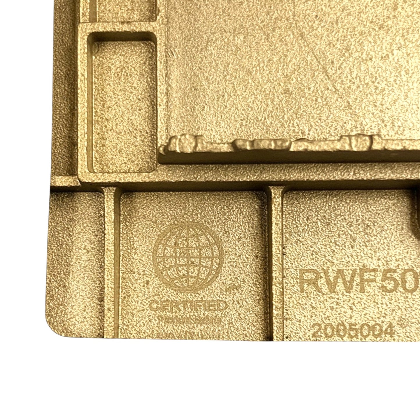Close-up of a gold-toned textured metal or plastic component with embossed certification text and part numbers, shown against a white background.