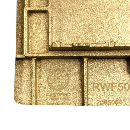 Close-up of a gold-toned textured metal or plastic component with embossed certification text and part numbers, shown against a white background.