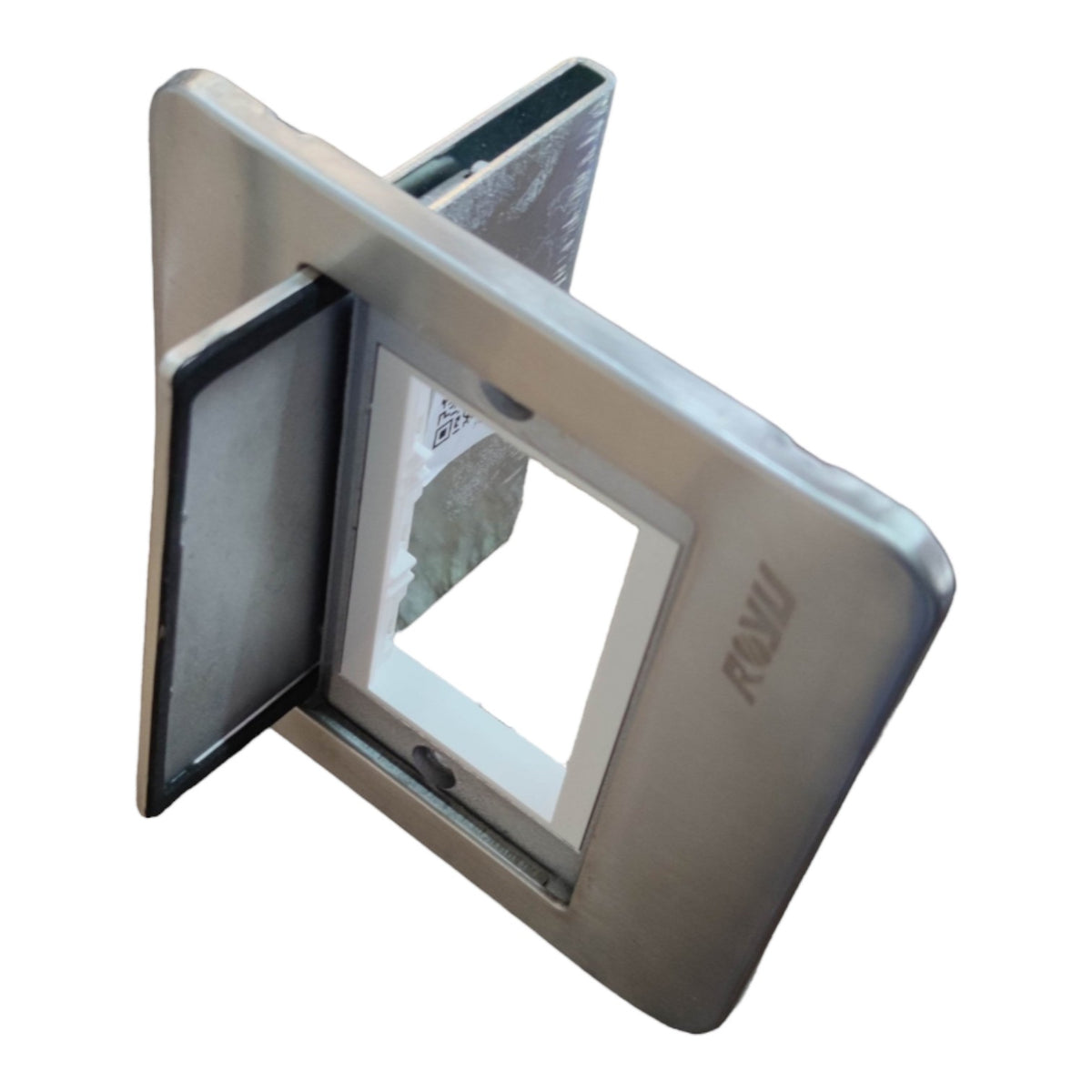 A square metallic silver electrical outlet cover plate with a recessed center and a small brand mark reading 'RAVI' on the right side, shown on a plain white background.