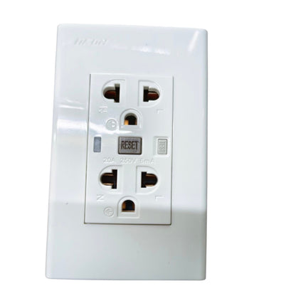 A white plastic dual outlet power strip with a central reset button, photographed against a plain white background.