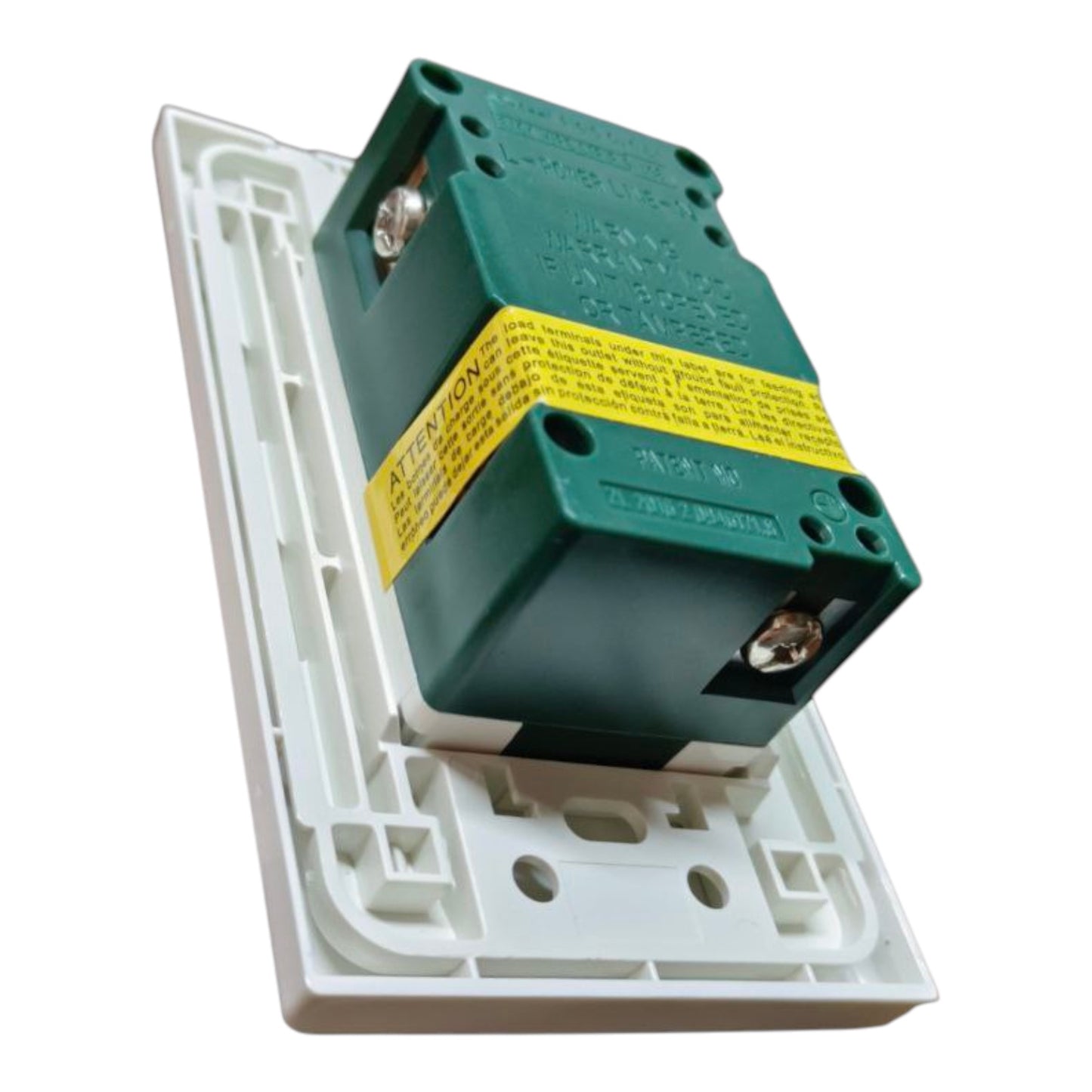A green electrical switch component mounted on a white plastic backplate, with a yellow warning label around the middle, isolated on a white background.