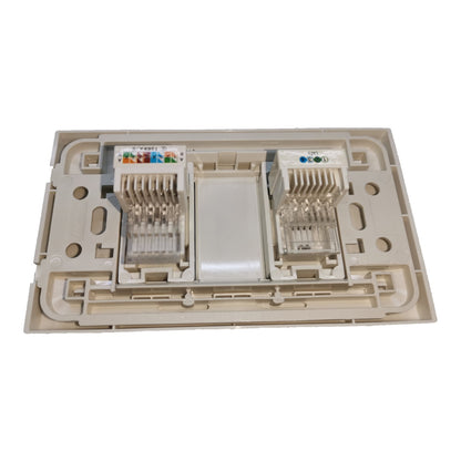 A beige plastic RJ45 network jack module with two ports, shown from the underside against a plain white background.