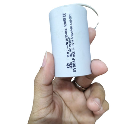 Syscap 10MFD Motor Running Capacitor held in hand, designed for enhancing motor efficiency