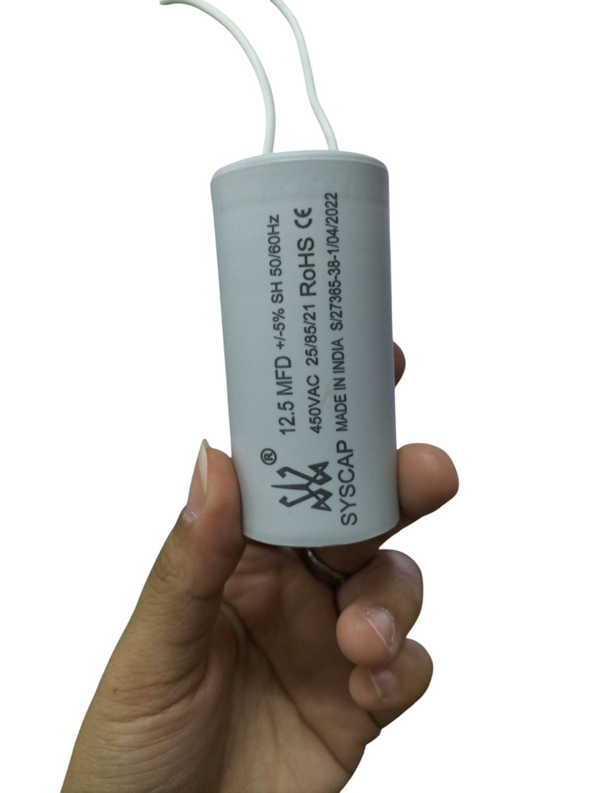 Syscap Motor Capacitor 12.5 MFD 450V for electrical applications, holding in a hand