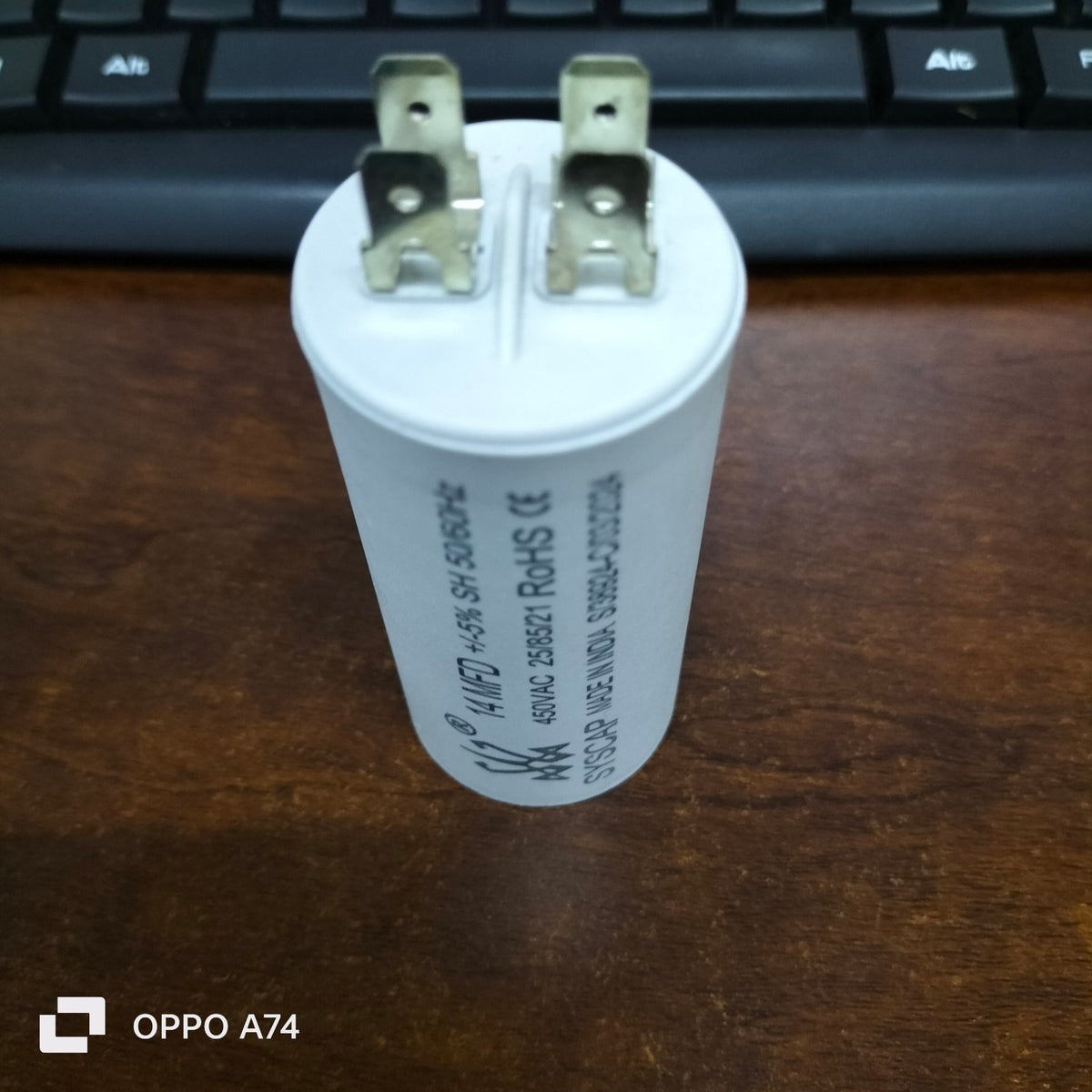 Syscap Motor Capacitor for electrical circuitry with two terminals on a white cylindrical body