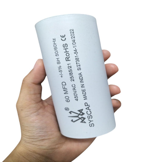 Hand holding Syscap 60MFD 450V AC motor running capacitor for electrical circuitry and parts