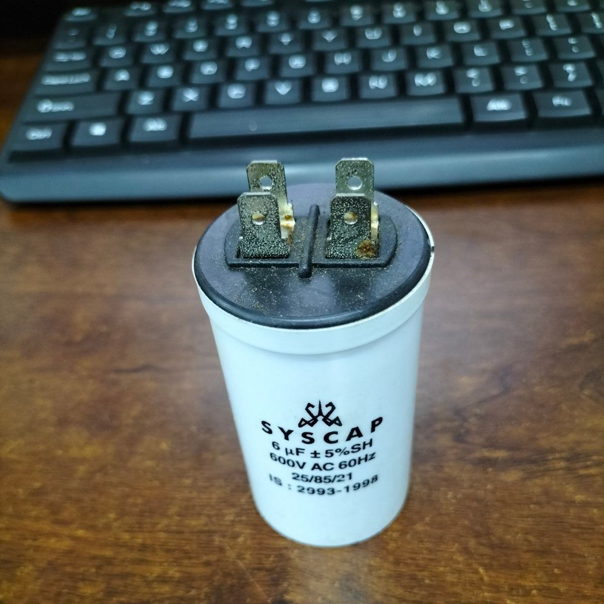 Syscap Motor Capacitor for electrical circuitry applications, featuring a durable white casing with connectors