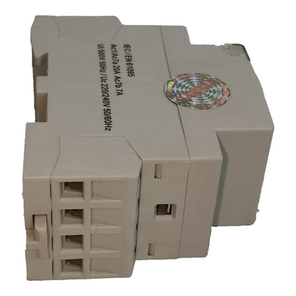 A beige industrial electronic module with a 4-pin terminal block on the front, printed specifications on the side, and a holographic sticker on top, shown against a plain white background.